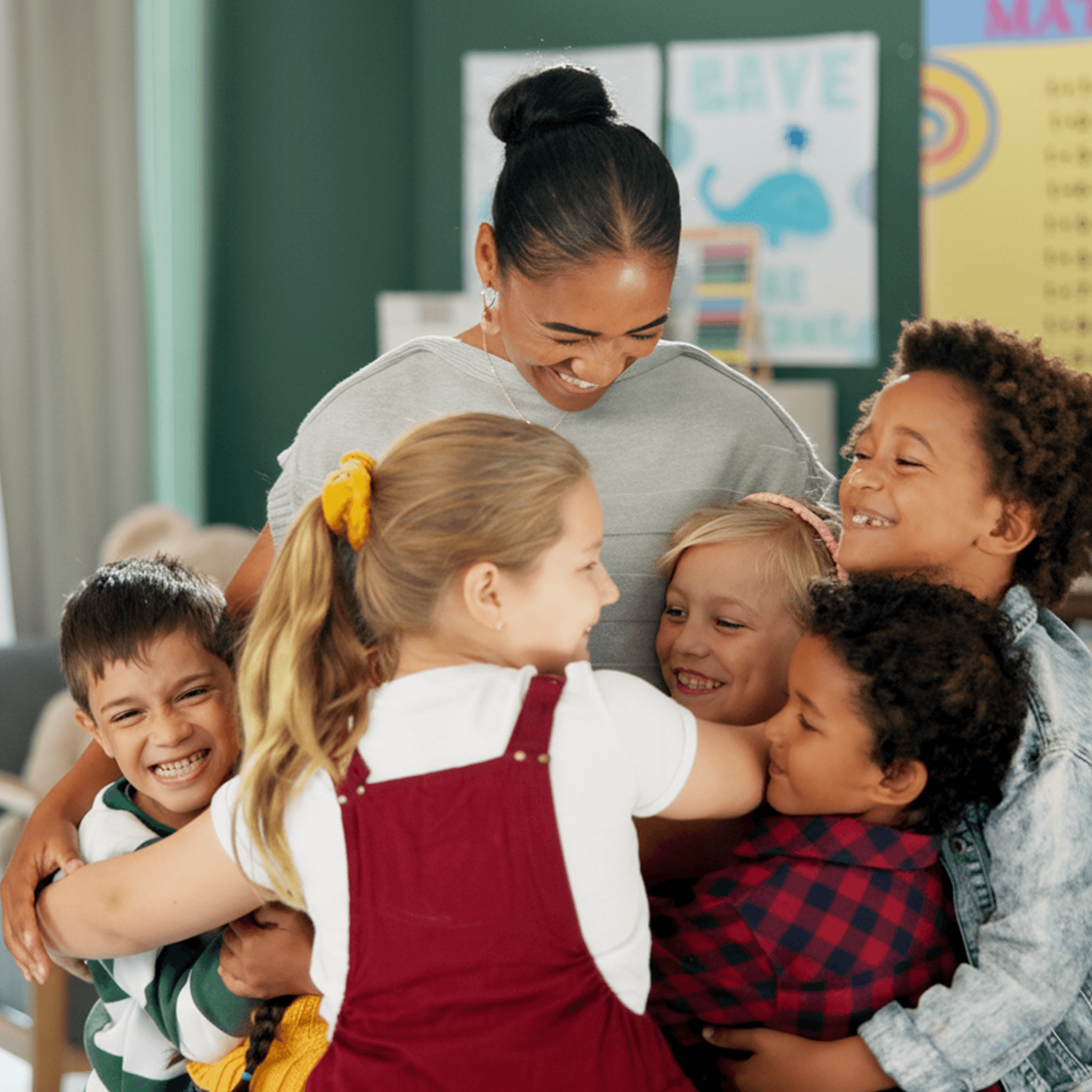 Teacher hugging students in a classroom