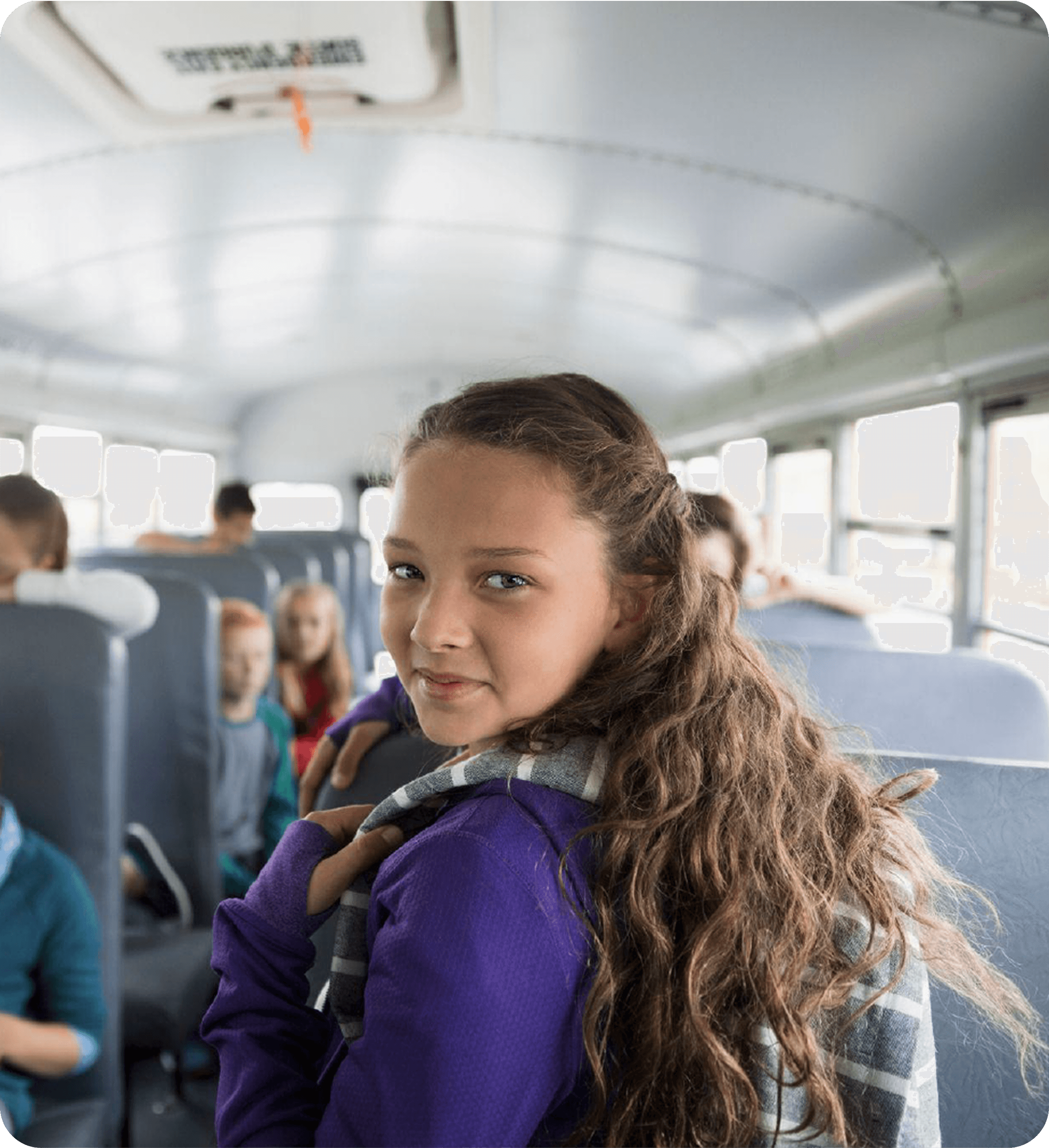Student on a school bus looking back at the camera